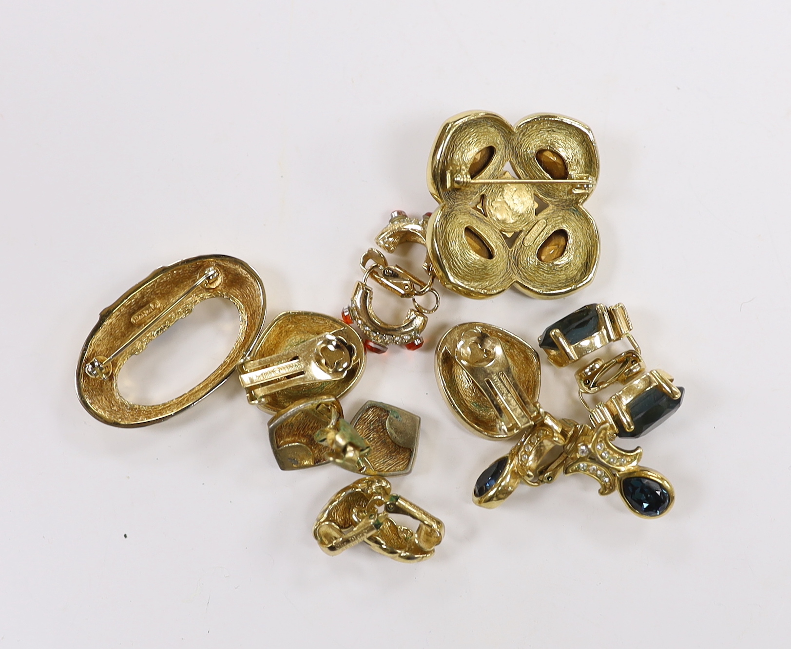 A Christian Dior gilt metal and coloured paste set quatrefoil brooch, 37mm and pair of similar ear clips, five other assorted pairs of Dior ear clips and a Dior brooch.